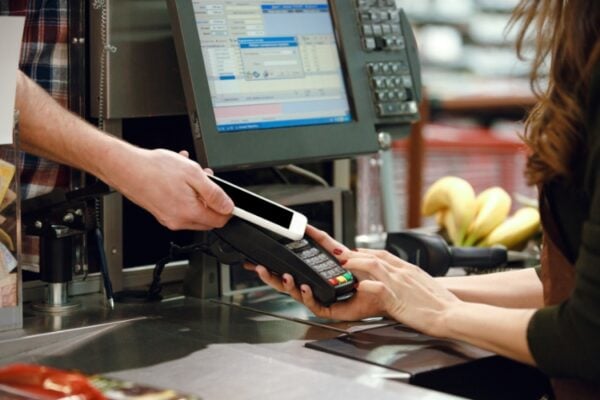A person is paying at a point of sale system using their mobile phone