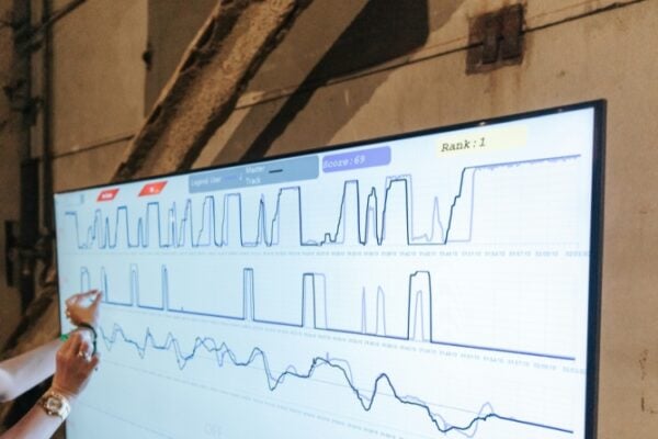 A person is reviewing data on a large screen