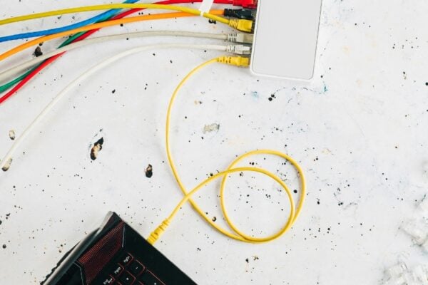 A yellow network cable is plugged into a laptop